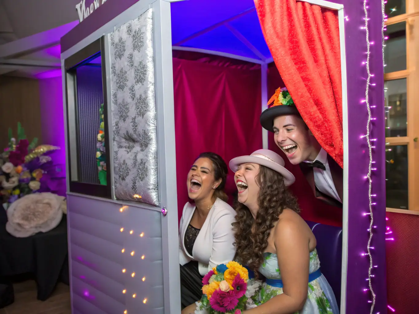 A 360 photo booth at a wedding reception, with guests laughing and interacting while capturing fun, immersive memories.